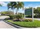 Lakeridge Falls Clubhouse sign surrounded by manicured landscaping and palm trees at 8224 Simpson Falls Ct # 8224, Sarasota, FL 34243