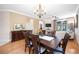 Charming dining room offers a wooden table for six, bright natural light, and an open view to the living area at 8224 Simpson Falls Ct # 8224, Sarasota, FL 34243