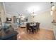 Bright dining area features wood floors, a chandelier, and an open concept layout to the living room at 8224 Simpson Falls Ct # 8224, Sarasota, FL 34243