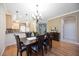 Traditional dining room features a wooden table for six, light fixtures, and opens to the kitchen at 8224 Simpson Falls Ct # 8224, Sarasota, FL 34243