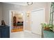 Elegant foyer with tile flooring, front door, and view into the living room at 8224 Simpson Falls Ct # 8224, Sarasota, FL 34243