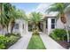 Inviting front entrance with lush landscaping and palm trees along the walkway at 8224 Simpson Falls Ct # 8224, Sarasota, FL 34243