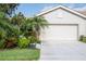 Charming home with a lush, landscaped front yard and a two-car garage with light stucco at 8224 Simpson Falls Ct # 8224, Sarasota, FL 34243