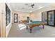 Bright game room features two well-lit billiard tables, perfect for entertaining guests and recreation at 8224 Simpson Falls Ct # 8224, Sarasota, FL 34243