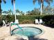 Inviting hot tub surrounded by comfortable seating and lush landscaping, creating a relaxing outdoor space at 8224 Simpson Falls Ct # 8224, Sarasota, FL 34243
