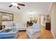 Open-concept living room showcasing hardwood floors, stylish seating, and an adjacent dining area at 8224 Simpson Falls Ct # 8224, Sarasota, FL 34243