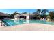 Bright swimming pool with marked lanes, surrounded by lounge chairs and lush landscaping at 8224 Simpson Falls Ct # 8224, Sarasota, FL 34243