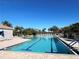 Bright swimming pool with marked lanes, surrounded by lounge chairs and lush landscaping at 8224 Simpson Falls Ct # 8224, Sarasota, FL 34243