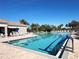 Bright swimming pool with marked lanes, surrounded by lounge chairs and lush landscaping at 8224 Simpson Falls Ct # 8224, Sarasota, FL 34243