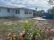 Home's backyard featuring a small patio and a blue storage container at 8409 43Rd W Ave, Bradenton, FL 34209