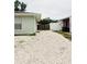 Backyard features white rock, fencing, and access to the neighbor's property at 8409 43Rd W Ave, Bradenton, FL 34209