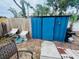 Backyard features a blue storage shed, patio furniture, and grill area for outdoor entertaining at 8409 43Rd W Ave, Bradenton, FL 34209