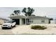 Well-maintained single-story home with white rock landscaping and a tidy front yard, plus white SUV in the driveway at 8409 43Rd W Ave, Bradenton, FL 34209