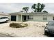 Neat single-story home with a rock garden, complemented by tasteful landscaping and attached garage at 8409 43Rd W Ave, Bradenton, FL 34209