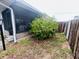A covered porch with outdoor seating offers a relaxing space next to a well-maintained yard at 8409 43Rd W Ave, Bradenton, FL 34209