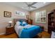Well-lit bedroom with shuttered windows, a full bed, and wood furnishings at 915 Sw Barclay Ct, Venice, FL 34293