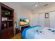 Relaxing bedroom with a TV, a bookshelf, and ample closet space at 915 Sw Barclay Ct, Venice, FL 34293