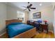 Inviting bedroom featuring a wooden bed frame and a cozy workspace at 915 Sw Barclay Ct, Venice, FL 34293