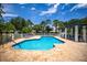 A lovely community pool features plenty of seating and a covered cabana area for shade at 915 Sw Barclay Ct, Venice, FL 34293