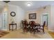 Elegant dining room showcasing a wooden table with seating for six, decorative lighting, and neutral wall colors at 915 Sw Barclay Ct, Venice, FL 34293