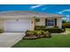 Charming single-story home featuring a well-manicured lawn, white garage door and a neatly landscaped garden at 915 Sw Barclay Ct, Venice, FL 34293