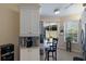 Functional kitchen area with white cabinetry, a breakfast bar, and sliding glass doors to the outdoor space at 915 Sw Barclay Ct, Venice, FL 34293