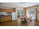 A community room kitchenette that includes cabinets, sink, refrigerator, and microwave, with seating nearby at 915 Sw Barclay Ct, Venice, FL 34293