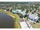 Aerial view of community pool and clubhouse by the lake, surrounded by lush green landscaping and homes at 11194 Spring Point Cir, Riverview, FL 33579