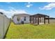 This home includes a backyard with a well-maintained lawn and a pergola-covered patio, perfect for outdoor activities at 11194 Spring Point Cir, Riverview, FL 33579
