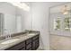 Bathroom featuring a double sink vanity, granite countertop, and vanity lighting at 11194 Spring Point Cir, Riverview, FL 33579