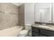 Tiled bathroom with granite countertops and tiled shower/tub at 11194 Spring Point Cir, Riverview, FL 33579