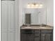 Bathroom with double sinks, granite counters, vanity lighting, and a closet at 11194 Spring Point Cir, Riverview, FL 33579