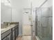 Modern bathroom boasts a double vanity with granite counters and a glass-enclosed shower at 11194 Spring Point Cir, Riverview, FL 33579