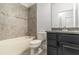Modern bathroom with granite countertops and tiled shower/tub combo at 11194 Spring Point Cir, Riverview, FL 33579
