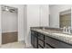 Bathroom featuring a double sink vanity, granite countertop, and a walk-in shower at 11194 Spring Point Cir, Riverview, FL 33579