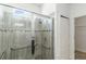 Modern tiled shower with glass doors, grab bars and a window for natural light at 11194 Spring Point Cir, Riverview, FL 33579