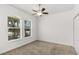 Bright bedroom with large windows, carpet flooring, and a ceiling fan at 11194 Spring Point Cir, Riverview, FL 33579