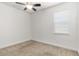 Neutral bedroom with a ceiling fan and large window at 11194 Spring Point Cir, Riverview, FL 33579