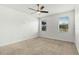 Neutral bedroom with ceiling fan and views to the outside from two windows at 11194 Spring Point Cir, Riverview, FL 33579