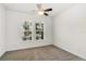 Bright bedroom features neutral carpet, ceiling fan and two windows overlooking the neighborhood at 11194 Spring Point Cir, Riverview, FL 33579