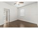 Bedroom with hardwood flooring, ceiling fan, and access to bathroom at 11194 Spring Point Cir, Riverview, FL 33579