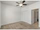 Carpeted bedroom with ceiling fan, closet and access to additional rooms at 11194 Spring Point Cir, Riverview, FL 33579