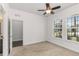Carpeted bedroom with a ceiling fan and windows offering a neighborhood view at 11194 Spring Point Cir, Riverview, FL 33579