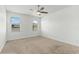Bright carpeted bedroom features a ceiling fan and two windows with coverings at 11194 Spring Point Cir, Riverview, FL 33579