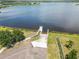 Community boat ramp and dock on a serene lake surrounded by grassy areas and lush greenery at 11194 Spring Point Cir, Riverview, FL 33579