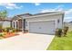 Beautiful home with stone facade, two-car garage, and well-manicured lawn at 11194 Spring Point Cir, Riverview, FL 33579