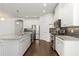 Modern kitchen with stainless appliances, granite countertops, and white cabinetry at 11194 Spring Point Cir, Riverview, FL 33579