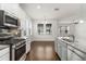 Bright kitchen featuring stainless steel appliances, granite countertops, and a central island at 11194 Spring Point Cir, Riverview, FL 33579