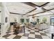 Spacious living room with checkered floors, coffered ceilings, stylish furniture, and ample natural light at 11194 Spring Point Cir, Riverview, FL 33579