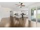 Open-concept living room and kitchen with hardwood floors and sliding glass doors to the patio at 11194 Spring Point Cir, Riverview, FL 33579